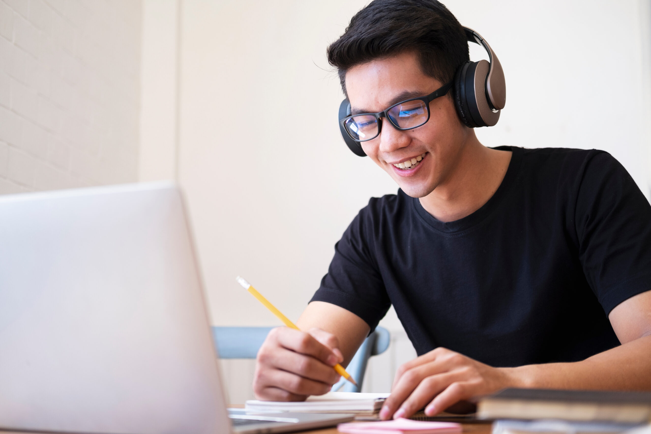 Young  man student study at home. He using laptop and learning online.